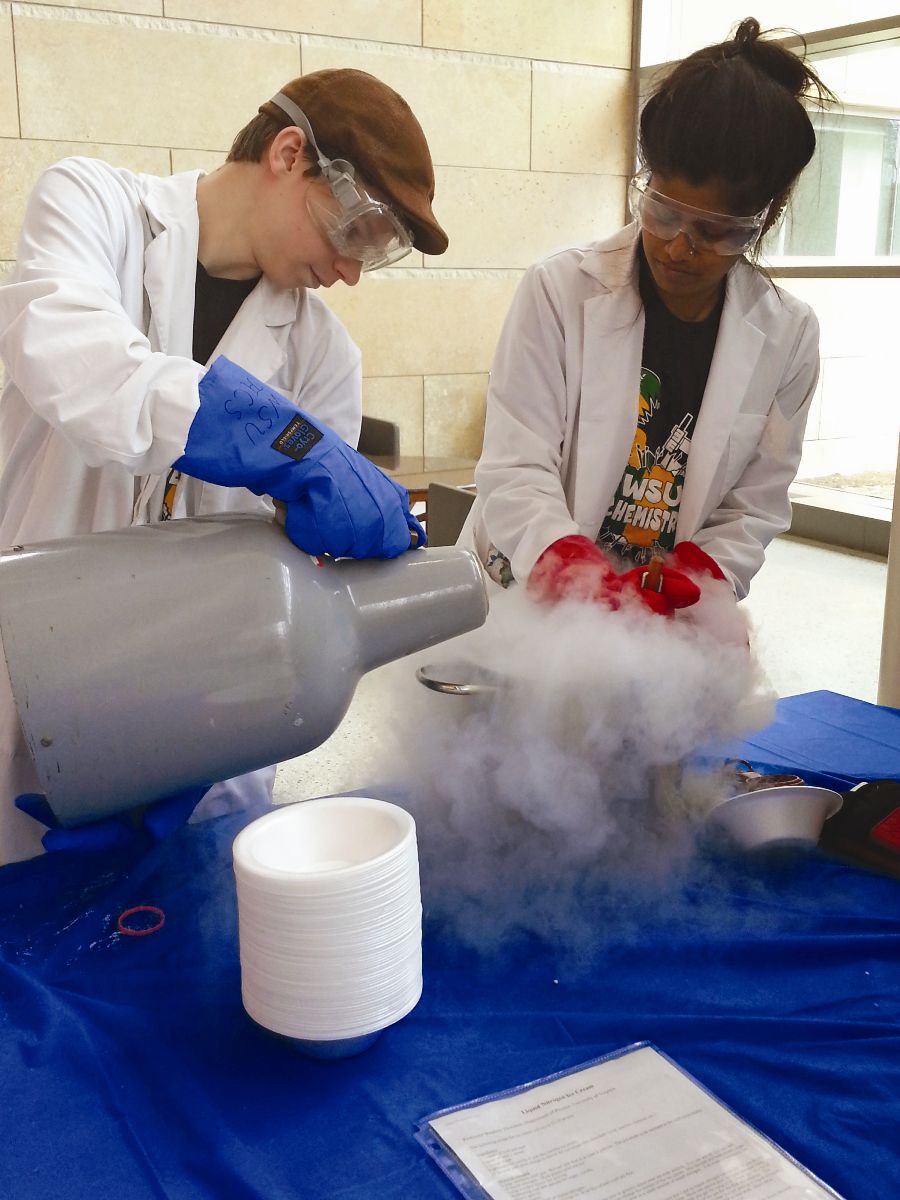 Chemistry students creating ice cream with dry ice.