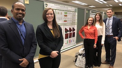 Research team with poster
