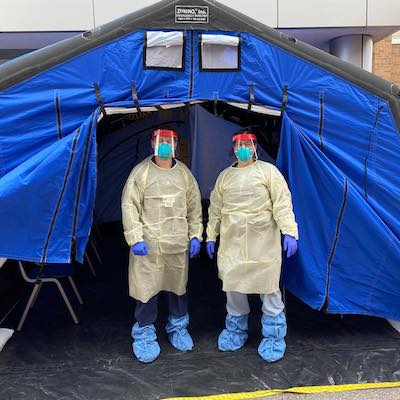 Sara Lolar and an RN staffing a COVID-19 screening tent.