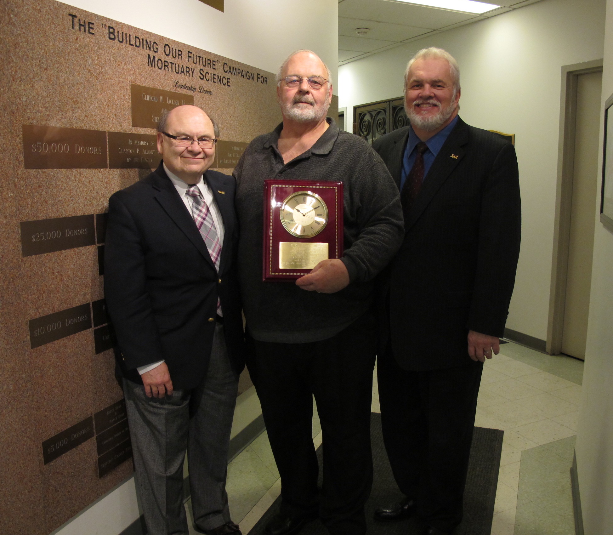 Peter Frade, David Ladd and Howard Normile at Ladd's 2013 retirement party in the Mortuary Science Building