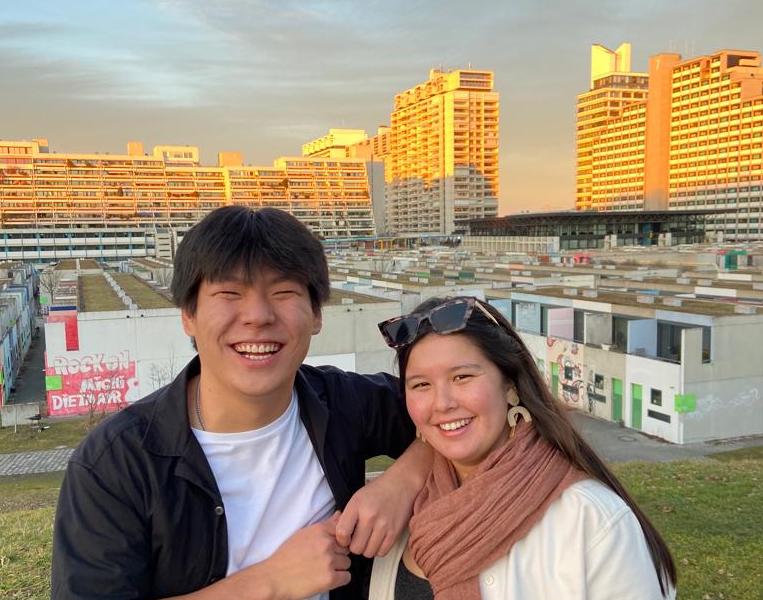 Junior Year in Munich alums and Wayne State graduates Jocelyn Nitta (right) Xinsheng Moss stand in front of the student housing complex in Olydorf, original built for the 1972 Olympic games.