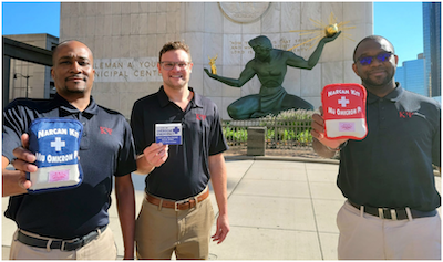 SNPhA Vice President Johnie Bailey, AMCP President-Elect Brian Globerman and SNPhA President Obioma Opara holding Narcan Rescue Kits provided by Kappa Psi Pharmaceutical Fraternity.