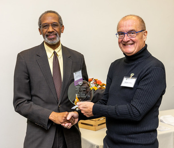 Louis Jones, a field archivist for Wayne State's Reuther Library, receives the Professional Service Award from Interim Dean Tom Walker.