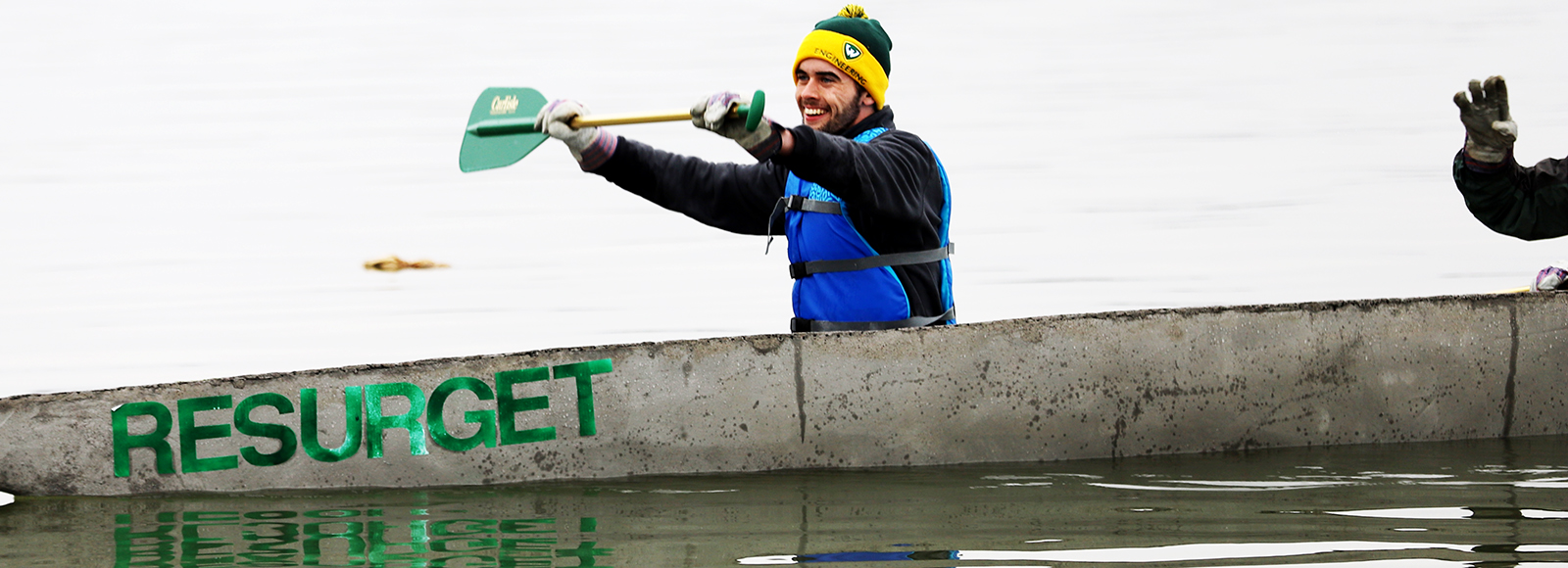Wayne State student Kelvin Selegean of Clinton Township smiles after crossing the finish line in the men's concrete canoe race on March 31.