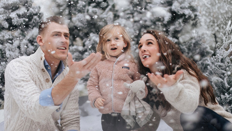 Casey Guevara with her husband James and their daughter Olivia play in the snow.