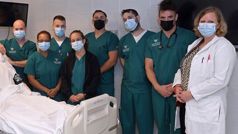 Casey Guevara (black sweater) poses with her VBSN cohort and clinical instructor Dr. Julia Farner (far right). Also pictured (L-R) are Ryan Oke, Tawanna Middlebrook, Jake Clor, Nick Ballantine, Daniel Rickard and Dave Dopierala. 