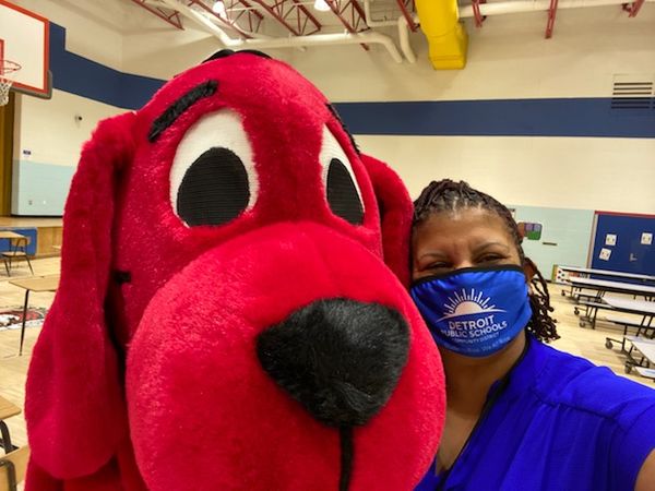 Vonetta Clark-Tooles, supervisor of K-12 literacy for Detroit Public Schools Community District helped to coordinate a surprise visit by Clifford the Big Red Dog to help distribute the tote bags