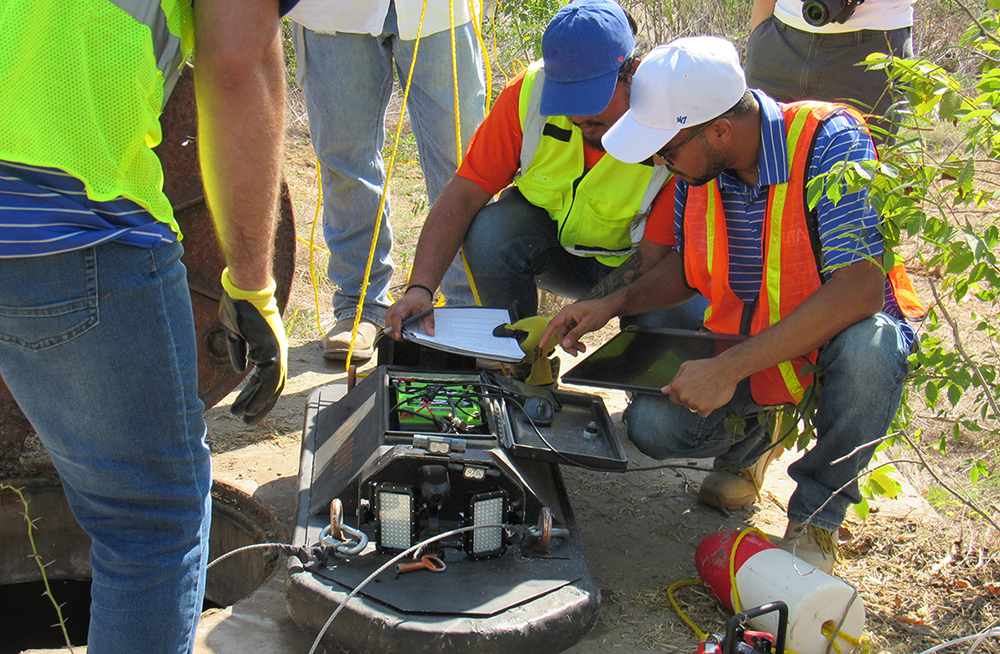 Members of the engineering research team reviews data captured by the unmanned robot after a pipeline inspection in the Dallas/Ft. Worth area.