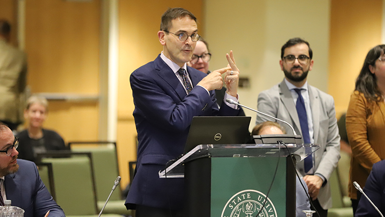 Professor Kevin Deegan-Krause introduces Wayne State senior Aaron Keathley to the Board of Governors at last Friday’s meeting in the Student Center Building. (Photo by Bill Roose)