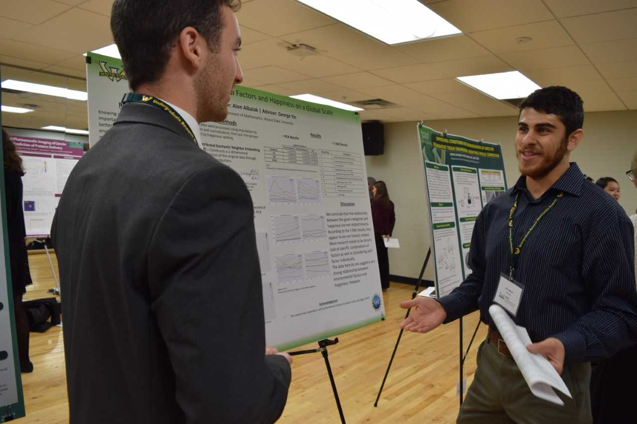 Alon Albalak, right, discusses his research with a fellow student.