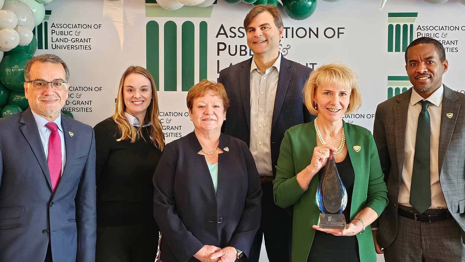 Wayne State University leadership accepts the Innovation and Economic Engagement Connections Award at the APLU's annual conference.