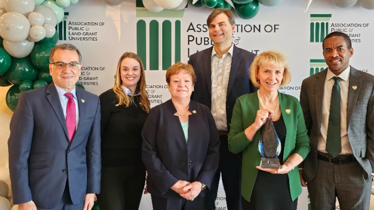 Wayne State University leadership accepts the the Innovation and Economic Engagement Connections Award at the APLU's annual conference.