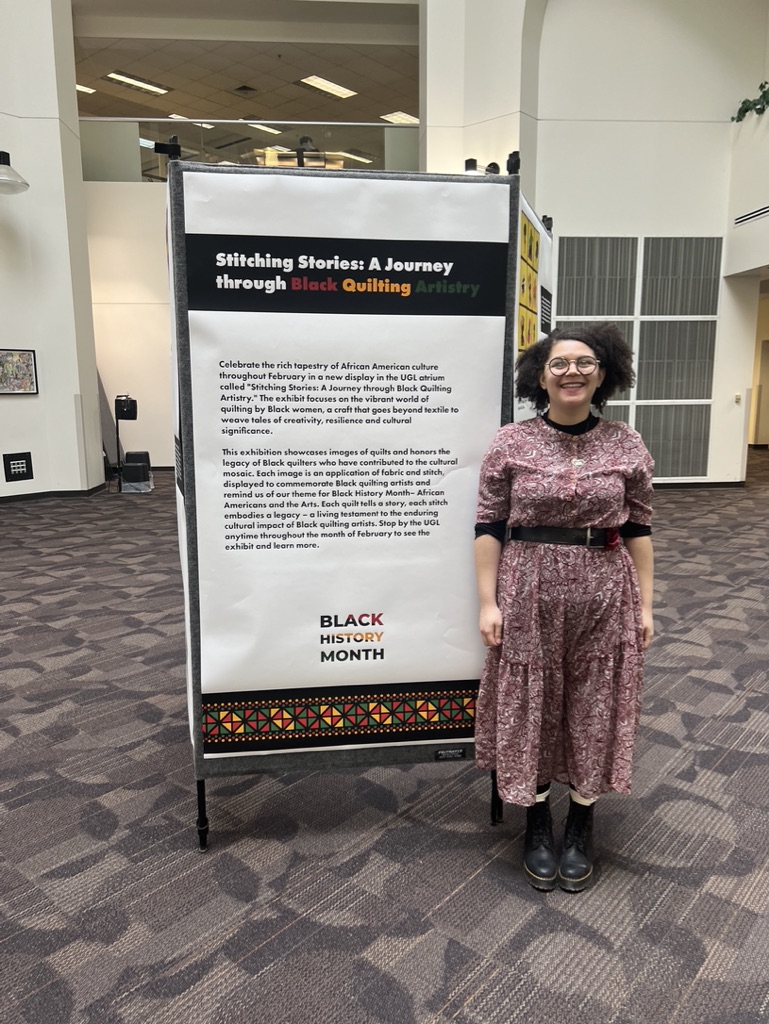 A student poses with a Black History Month display 