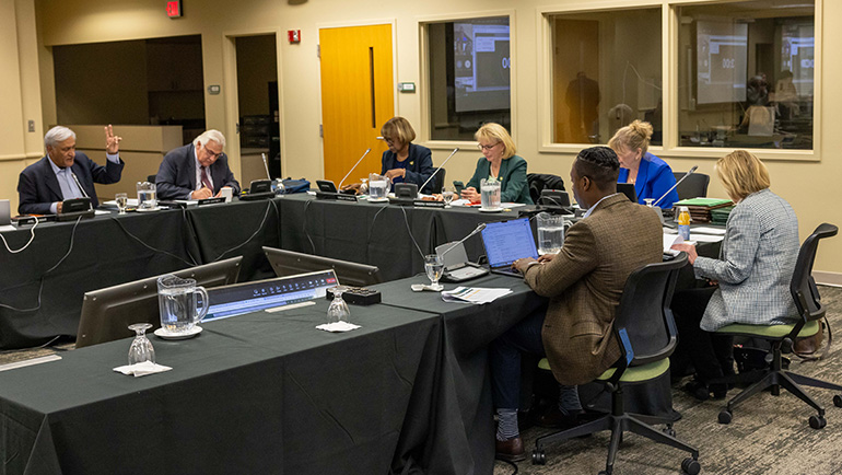 Board of Governors working at a table.