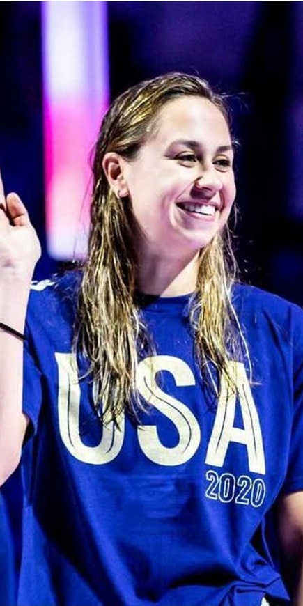 Catherine De Loof standing on the Olympic podium after making the 2021 USA Swimming Team