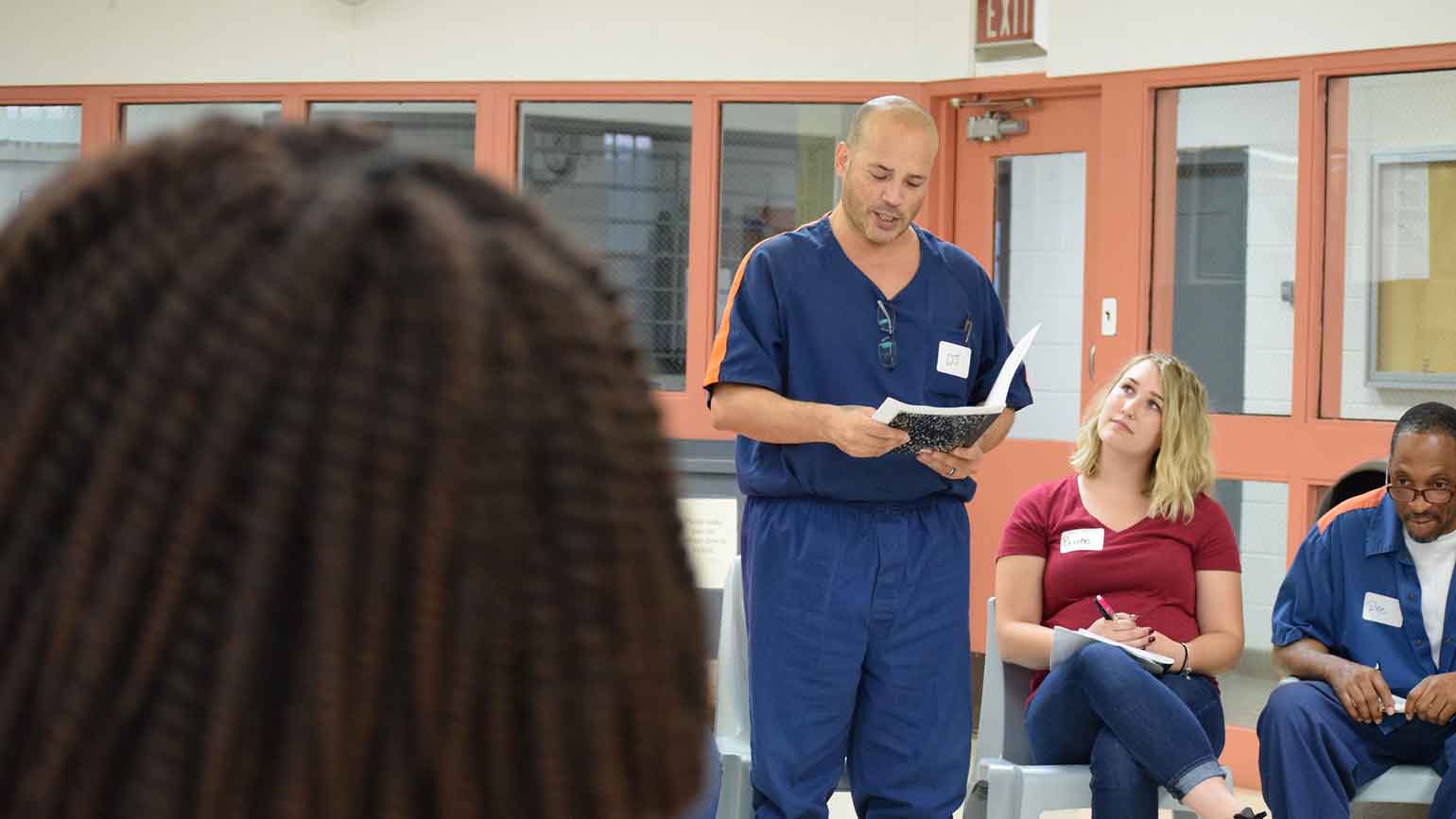 An inmate reads from a journal, as part of the Wayne State University Inside Out Prison Exchange Program.