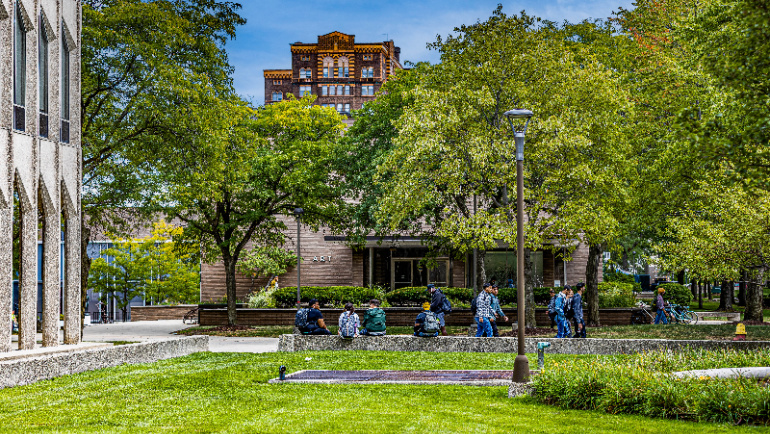 Students and faculty walk across Wayne State University's campus.