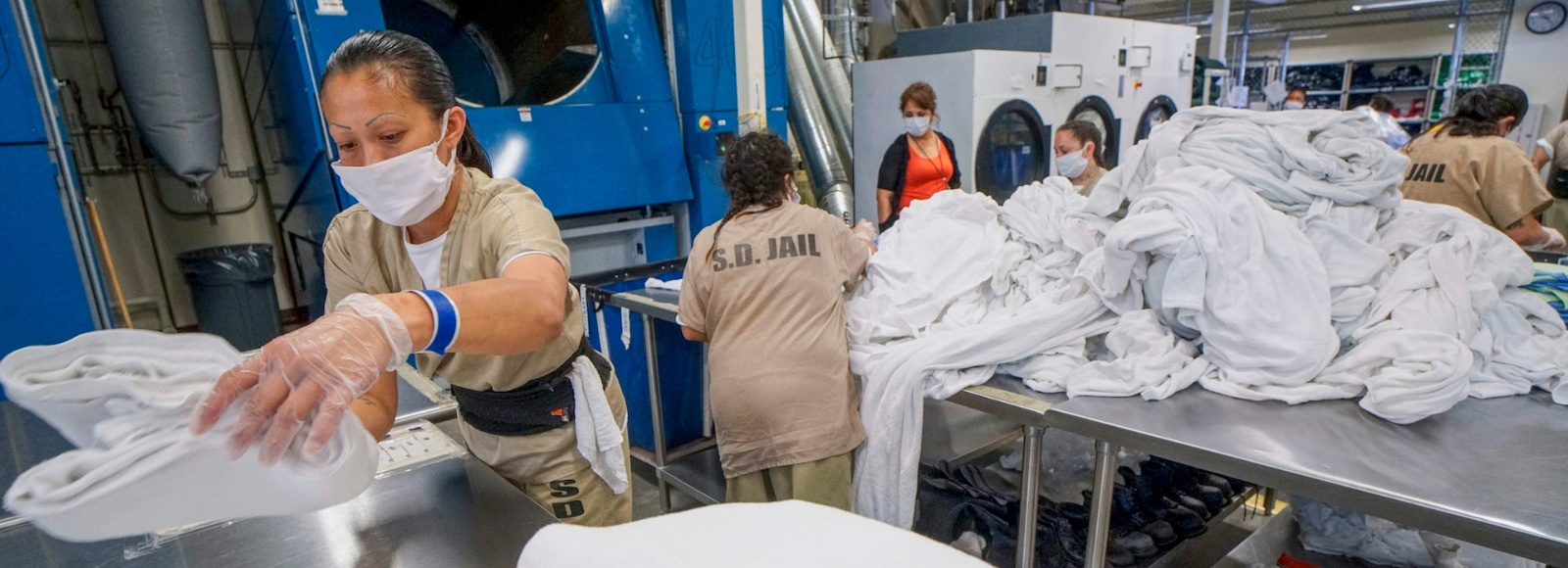 Female prison workers doing laundry
