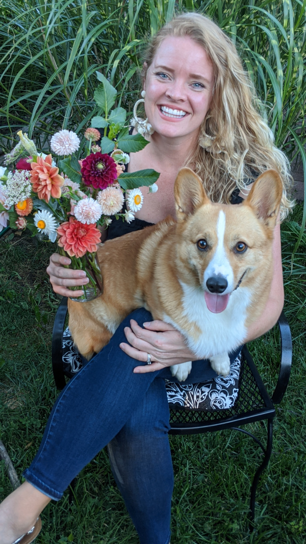 Courtney Durham sits with her corgi and an arrangement of fresh flowers from her garden. 