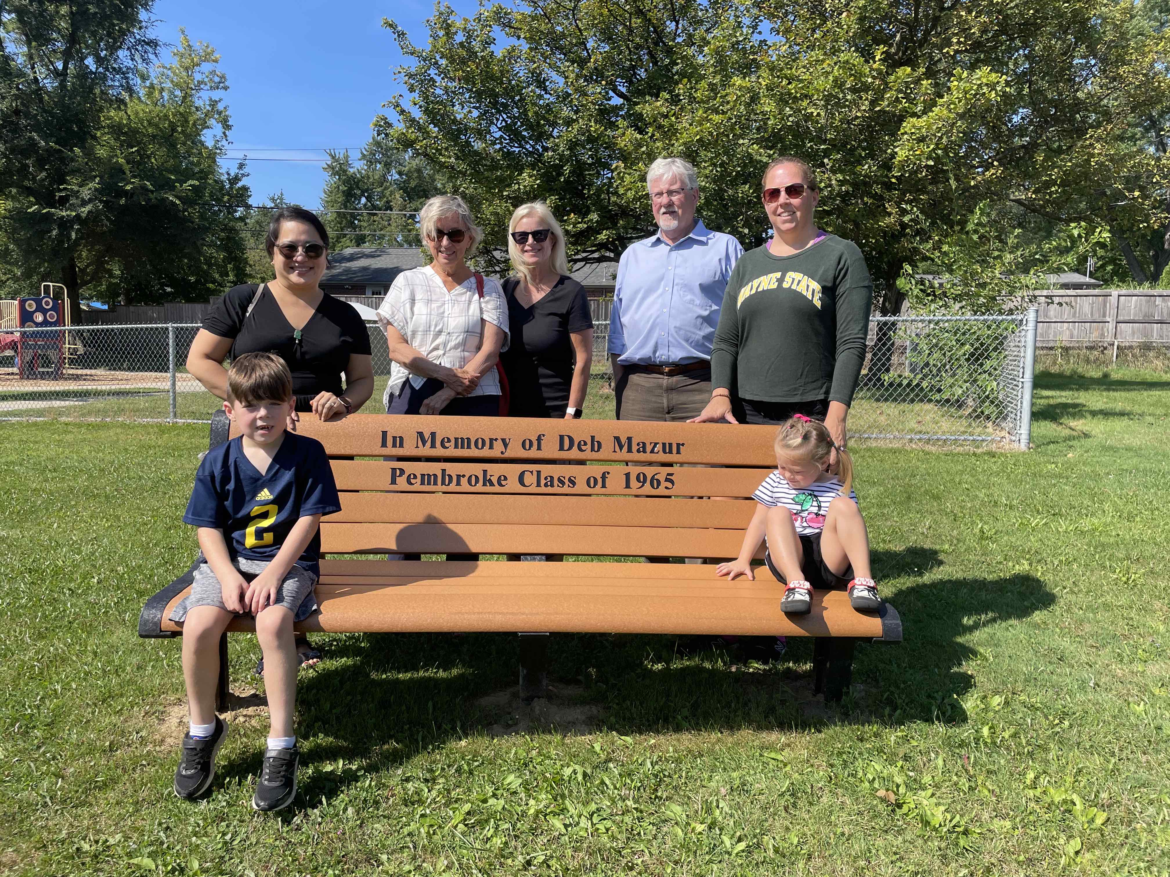 Faculty and staff gather around bench dedicated to the memory of Deb Mazur