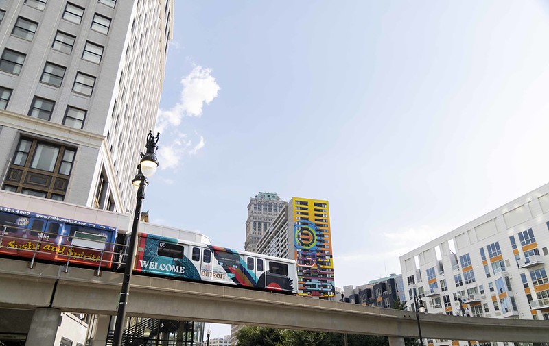A photo of Detroit's People Mover in the foreground. Buildings are in the background.