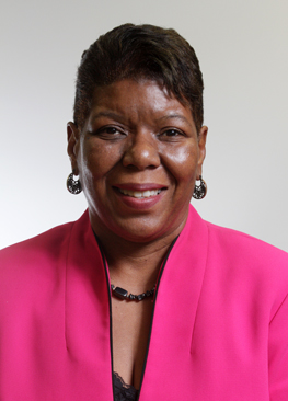 Dr. Felicia Grace wearing a pink blazer smiling in a headshot photo.