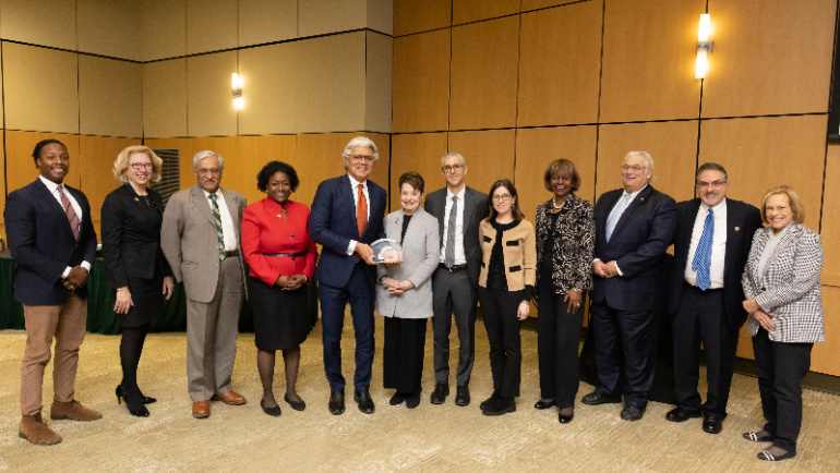 Wayne State President M. Roy Wilson and the Wayne State board of governors present Elaine Driker with the Eugene Driker award.
