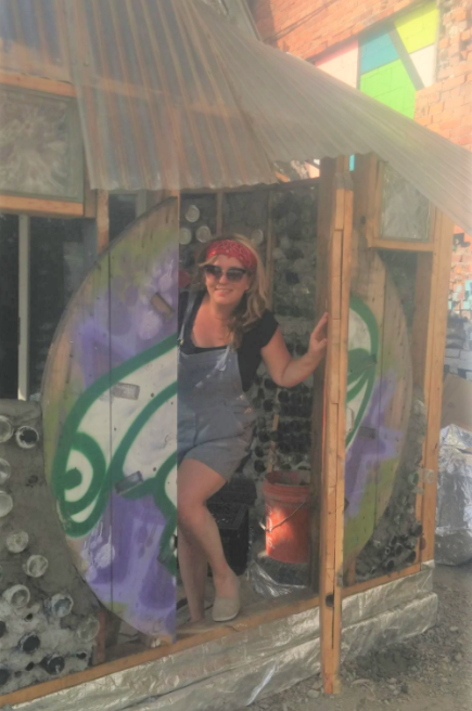 Brittany Mitchell-Kelley in an Earthship structure