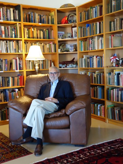 Dr. Echenberg sitting in front of books