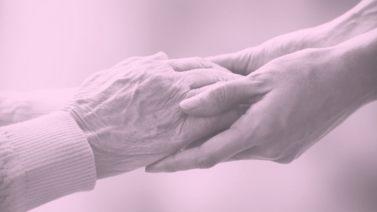 Woman's hands holding an elderly person's hands