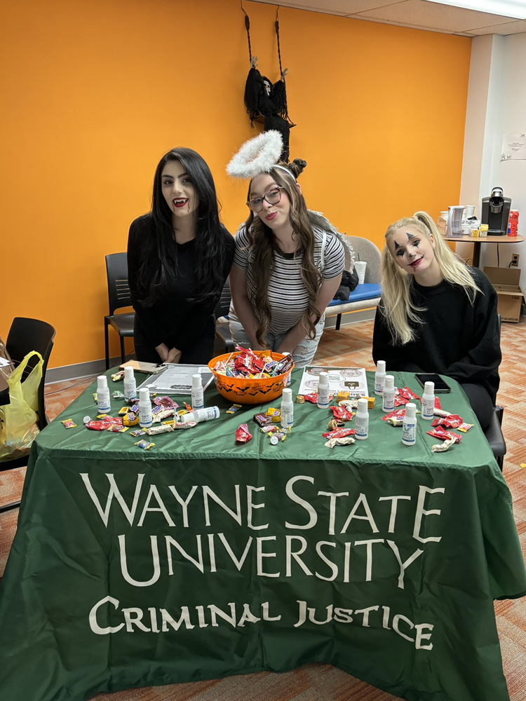 Students in costume at a table with candy
