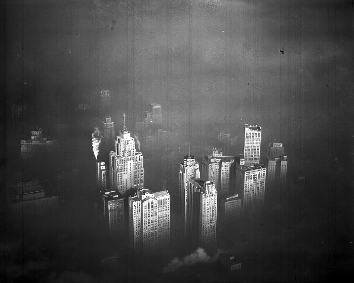 A dramatic photo above foggy Detroit