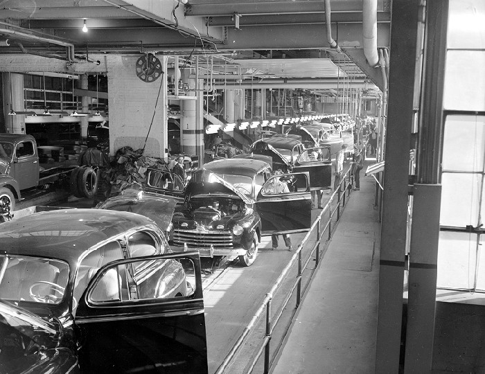 An aerial view of the ford assembly line and each car has it's driver's side door open