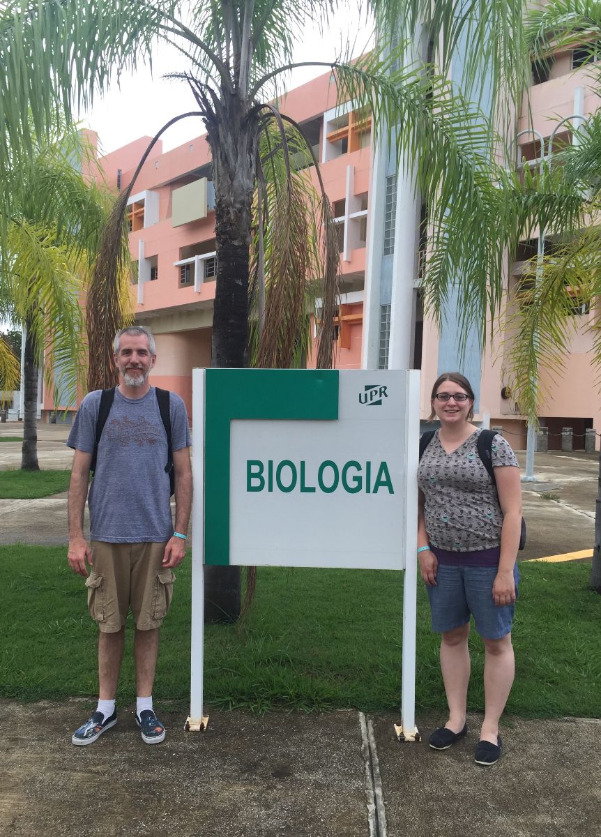 Darrin Hunt and Anna Boegehold in front of biologia sign.