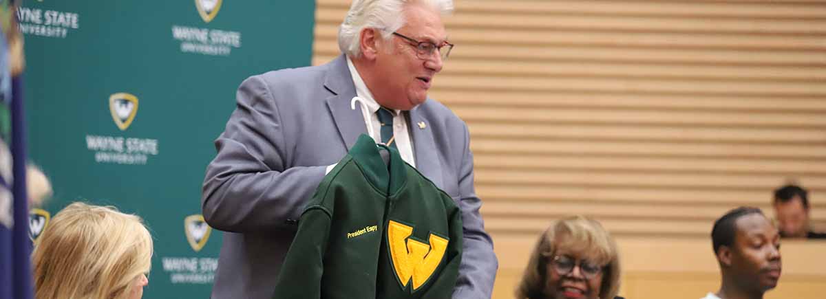 Board Chair Mark Gaffney presented, albeit virtually, a Wayne State letter jacket to President Kimberly Andrews Espy, Ph.D., after the Board of Governors unanimously elected her as the school's 13th president.
