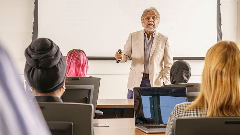 Professor lectures in a classroom.