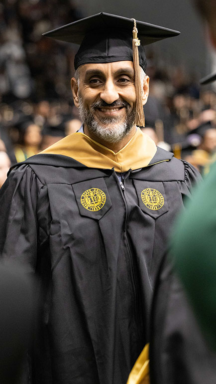 An older adults graduates from Wayne State.