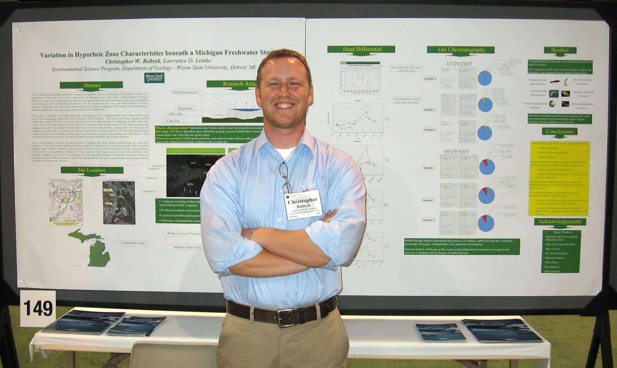 Chris Bobryk in front of presentation poster.