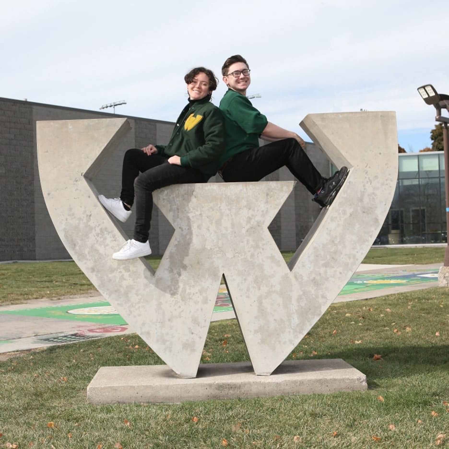 Haley and their brother sitting atop the big concrete W on Wayne State's campus
