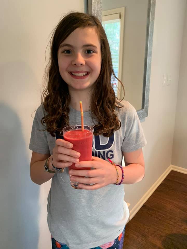 Young girl drinking a smoothie