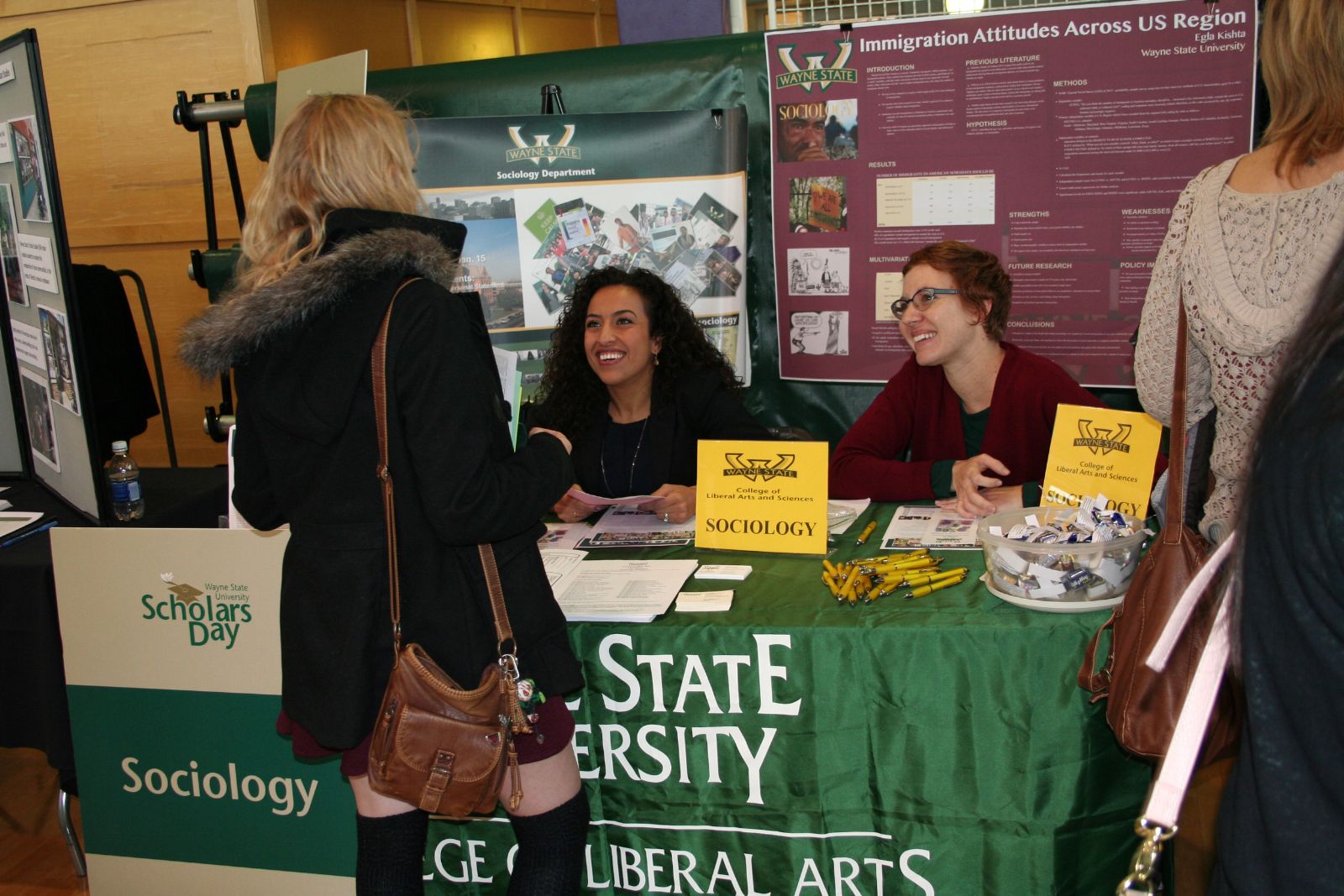 Assistant professor, Shirin Montazer, Ph.D., (left) and lecturer, Jessica Penwell Barnett, Ph.D., (right) greet prospective scholars and parents