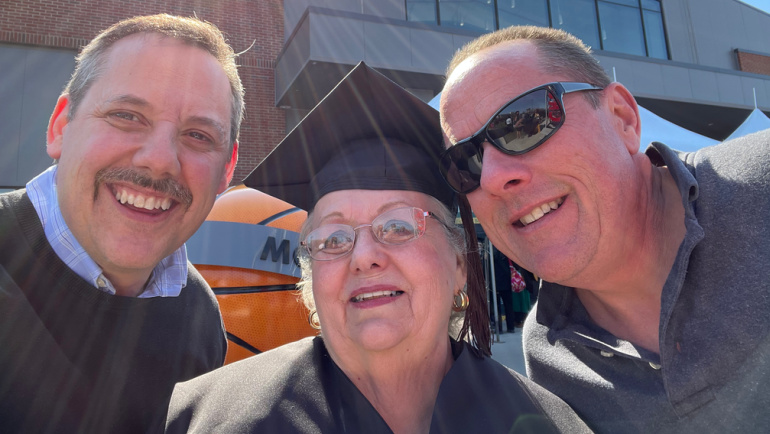 Linda Ignagni (center) poses for a photo with her sons Joseph and Dan at the Wayne State commencement ceremonies.
