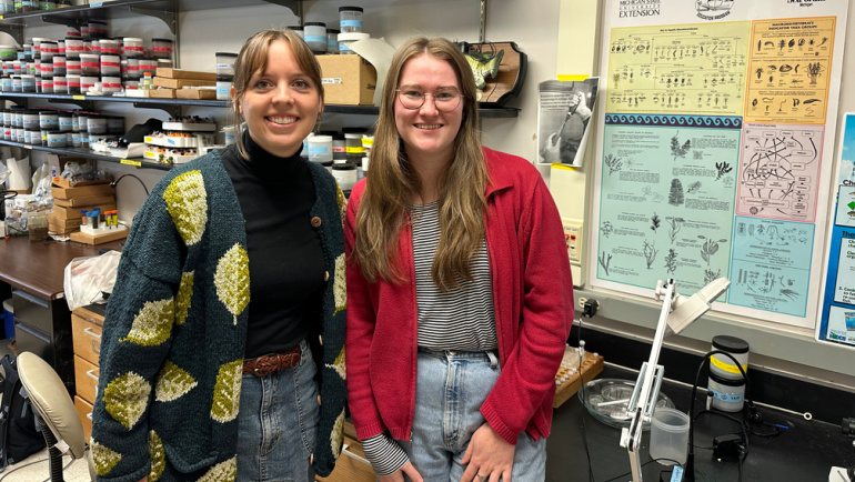 Wayne State University biology Ph.D. students Brenna Friday and Katrina Lewandowski pose for a photo in their lab.
