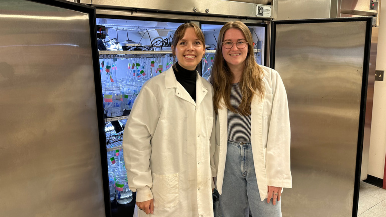 Biology Ph.D. students Katrina Lewandowski (left) and Brenna Friday pose for a photo in their lab.
