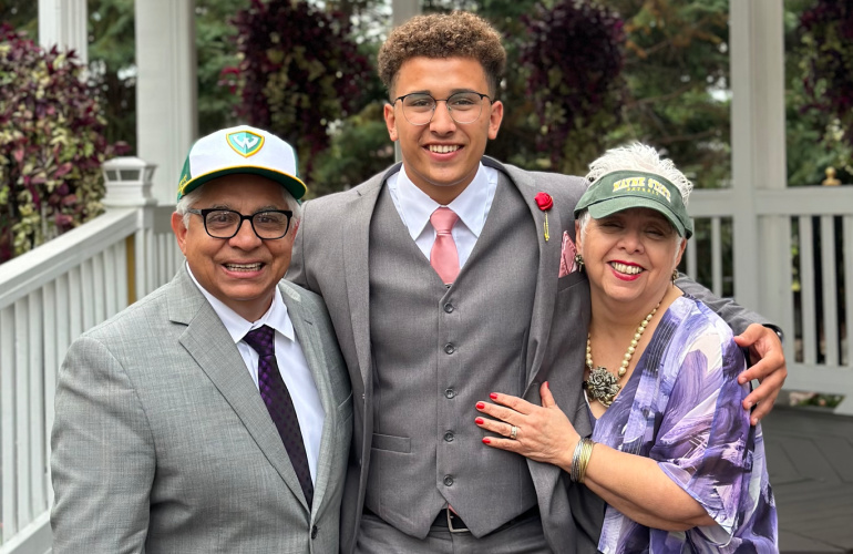 Wayne State student Michael Ramirez (center) poses for a photo with his great uncle Benny Esquivel (left) and great aunt Beatrice Esquivel, who are both Wayne State alumni.