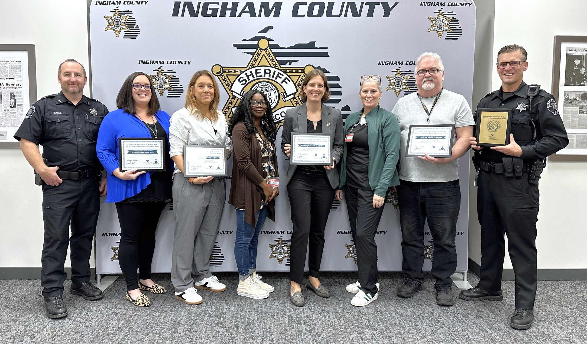 Team members show their awarded certificates from the CBHJ.