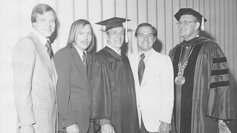 In 1974, Jack Hertel proudly poses for a photo with his sons (L-R) Dennis, Curtis and John, after he graduated from Wayne State with a bachelor degree in education. He earned his masters in 1980.
