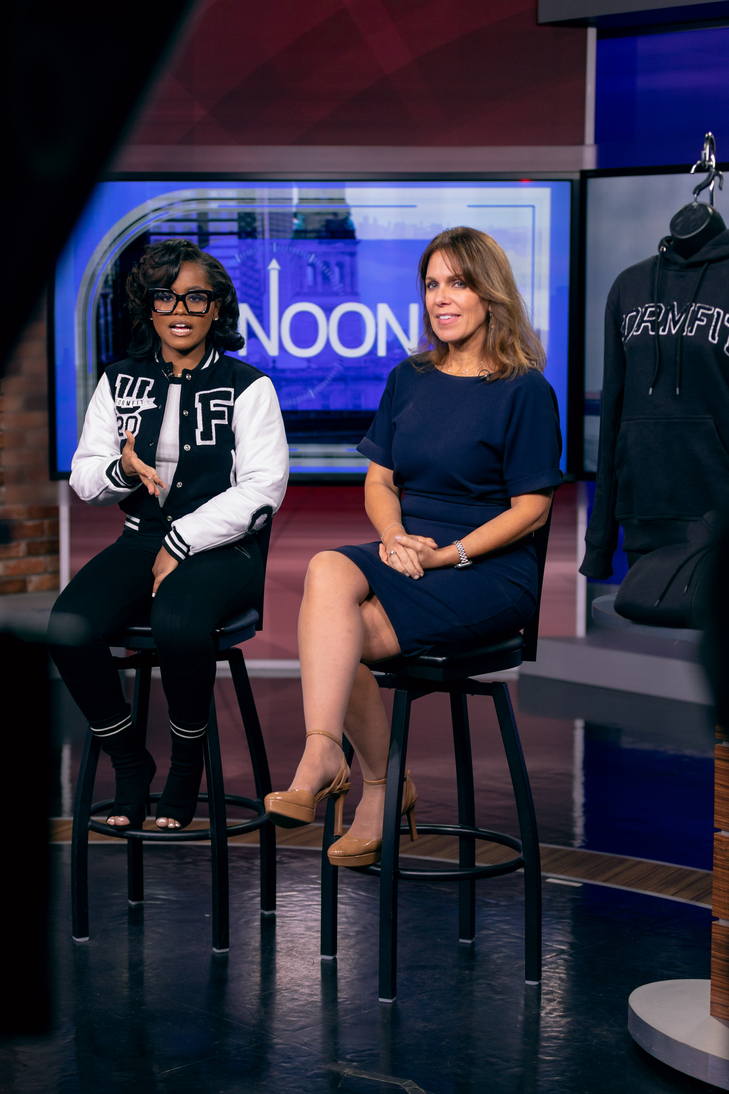 Two women sitting together on a news program