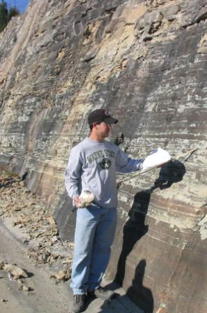 Jason Jweda taking a sample from a rock