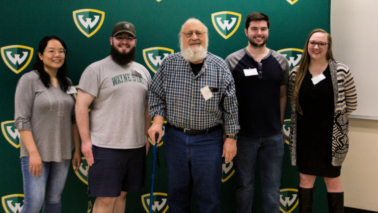 Alumnus Jim Kaskas, center, is recognized by students in the Department of Physics and Astronomy for his continued support of scholarships and research.